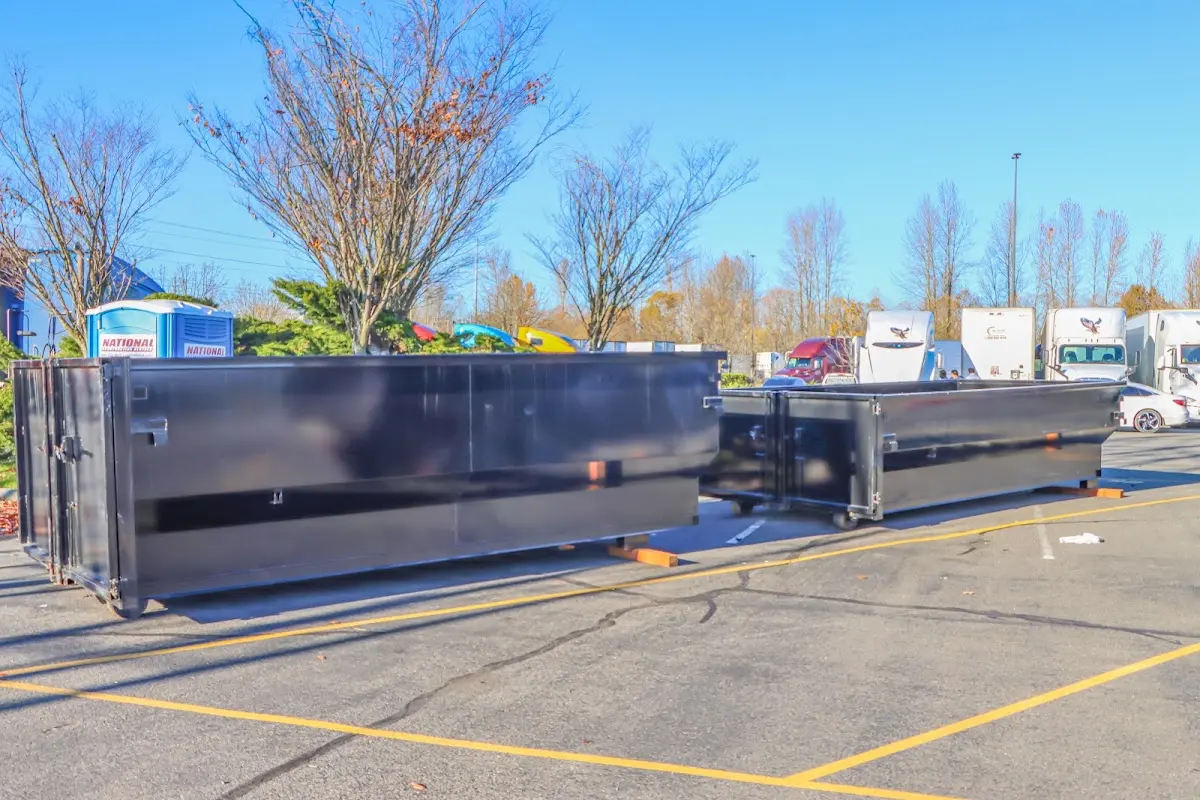 Professional dumpster rental service with roll-off container on residential driveway in Willard